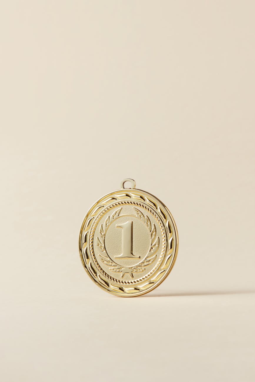 gold round pendant on beige background