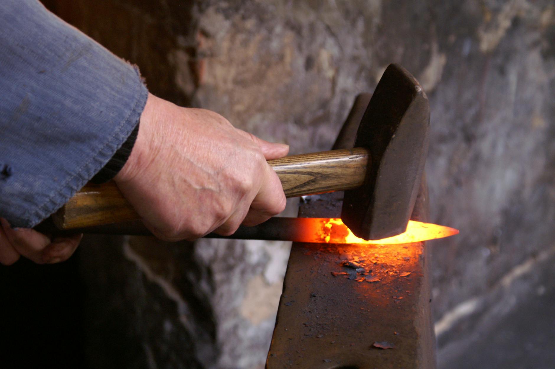 person holding forging metal
