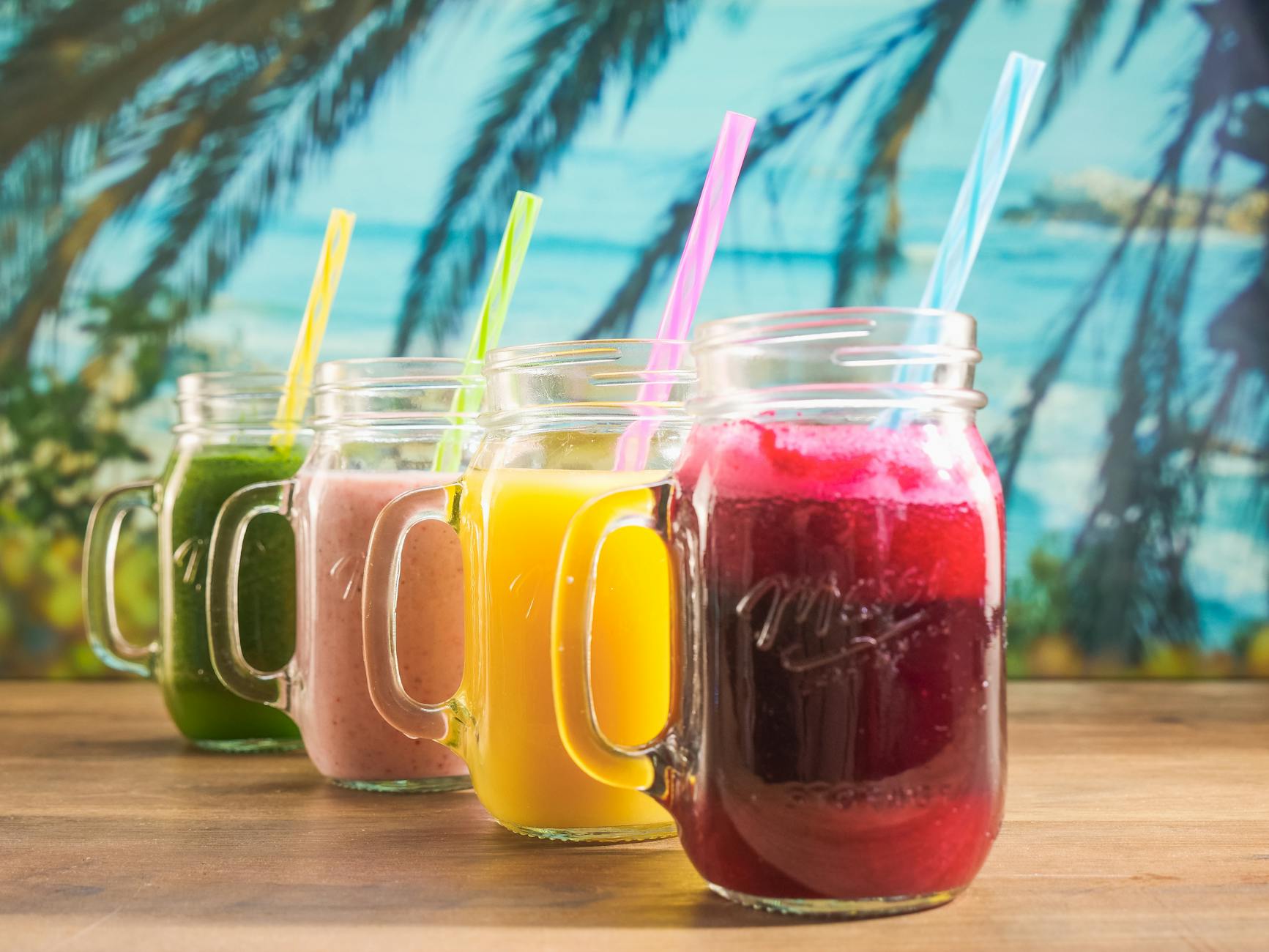 different flavors of fruit juice on mason jars