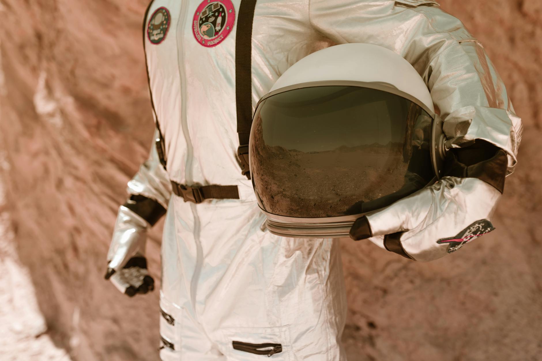 astronaut carrying his helmet
