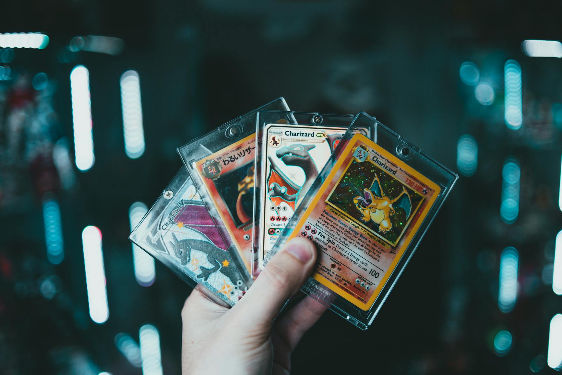 a person holding pokemon trading cards