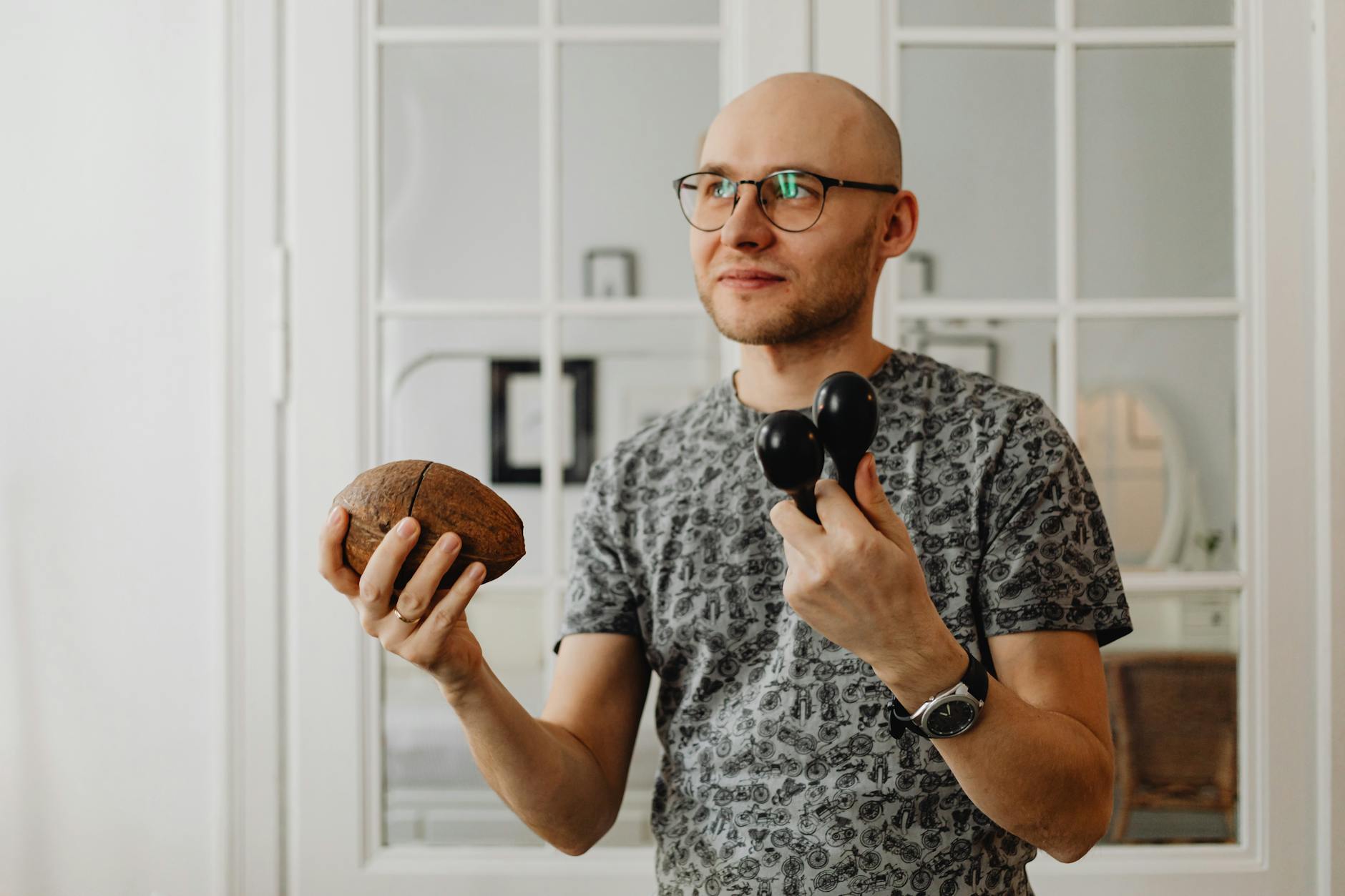 man in gray shirt holding a maracas