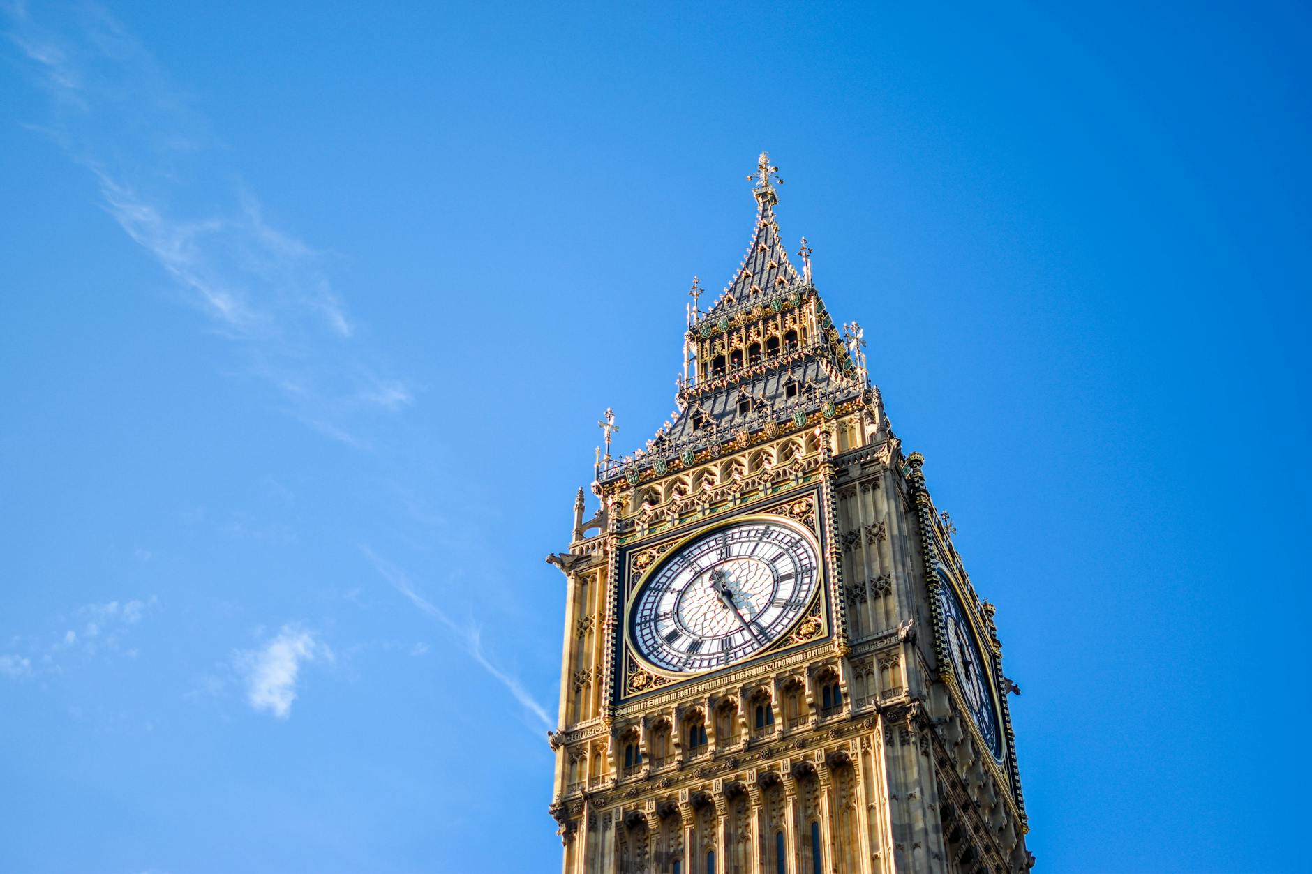 low angle view of clock tower against blue sky